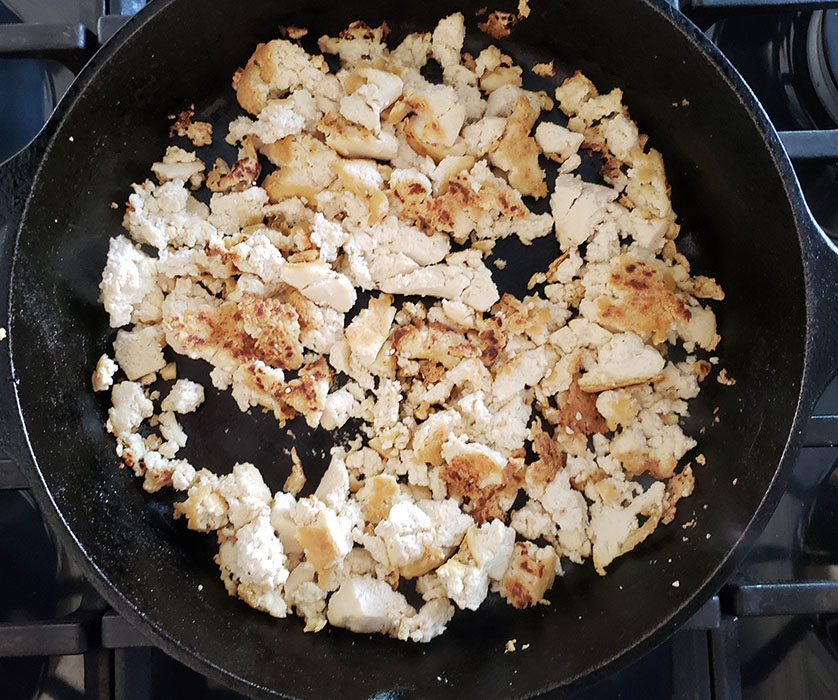 crumbled tofu cooking in a skillet