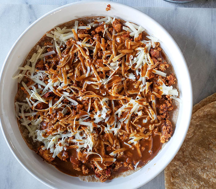 enchilada casserole cheese shreds, filling and sauce