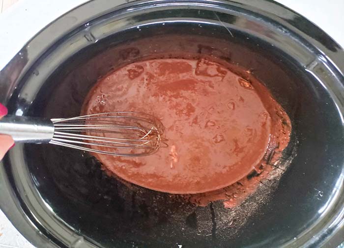 chicken tostada sauce mixed together in a slow cooker