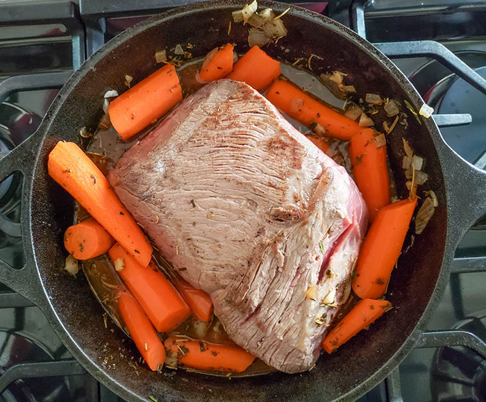 roast in pan with vegetables all ready for the oven