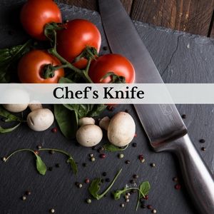 a picture of a chefs knife with tomatoes