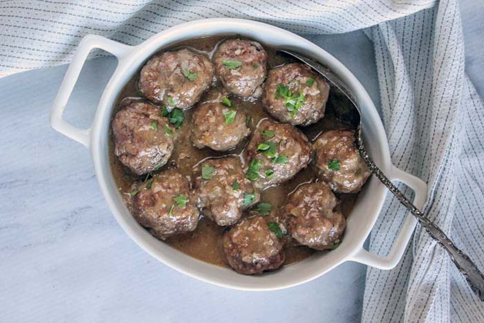 overhead view of meatballs in a white dish