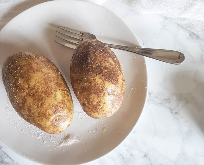 raw potatoes on a plate with a fork