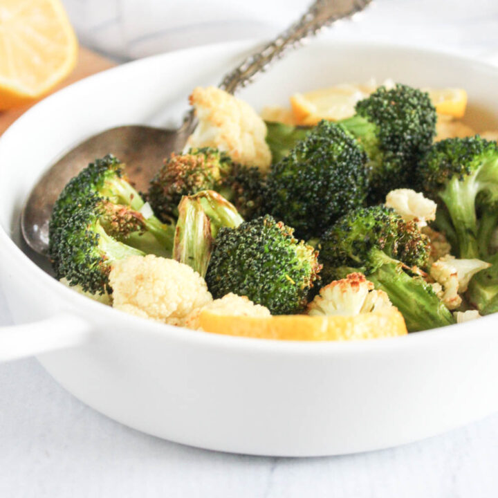broccoli and cauliflower in a dish with a spoon