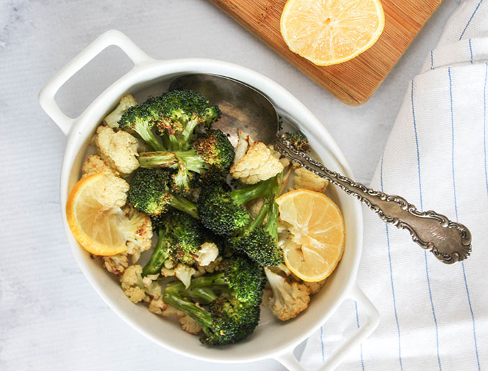 an overhead view of broccoli and cauliflower in a white dish