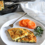 two slices of a frittata with oranges on a plate