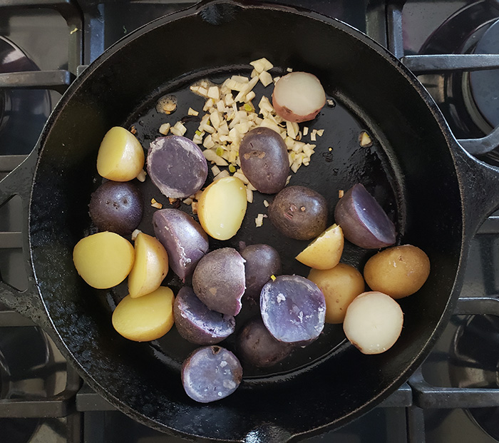 potatoes and garlic in a skillet