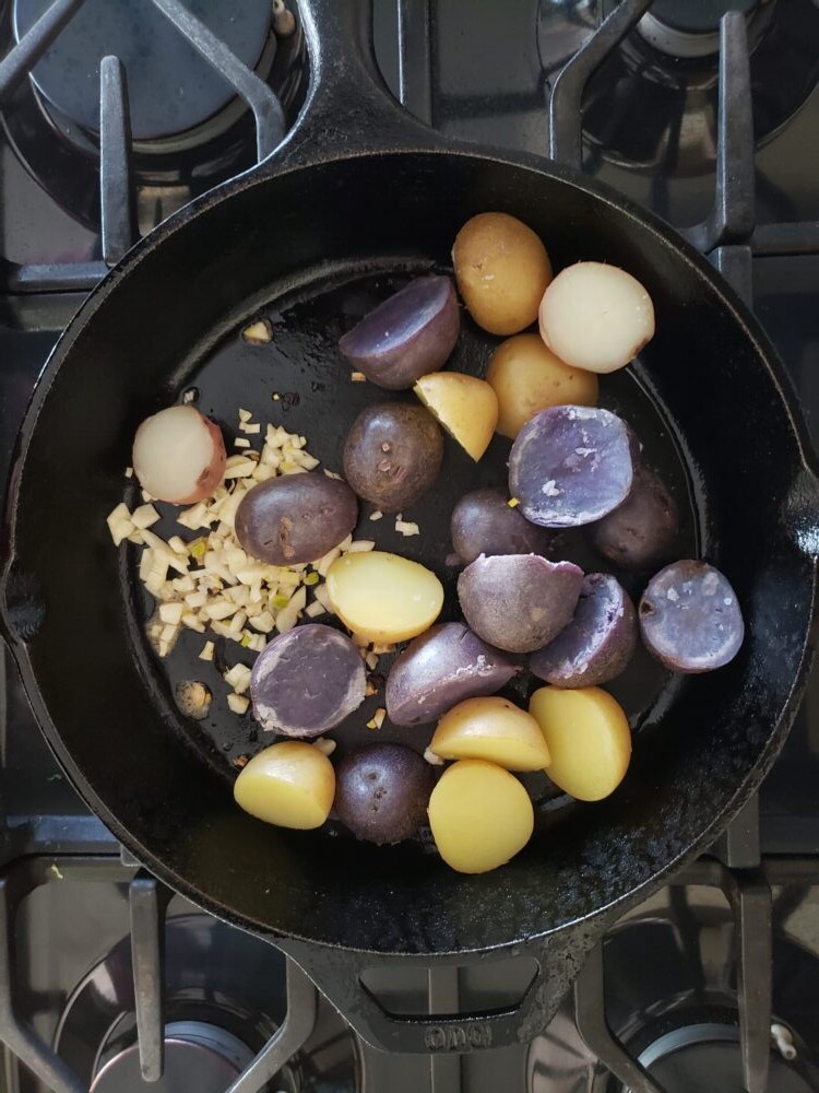 potatoes and garlic in a skillet