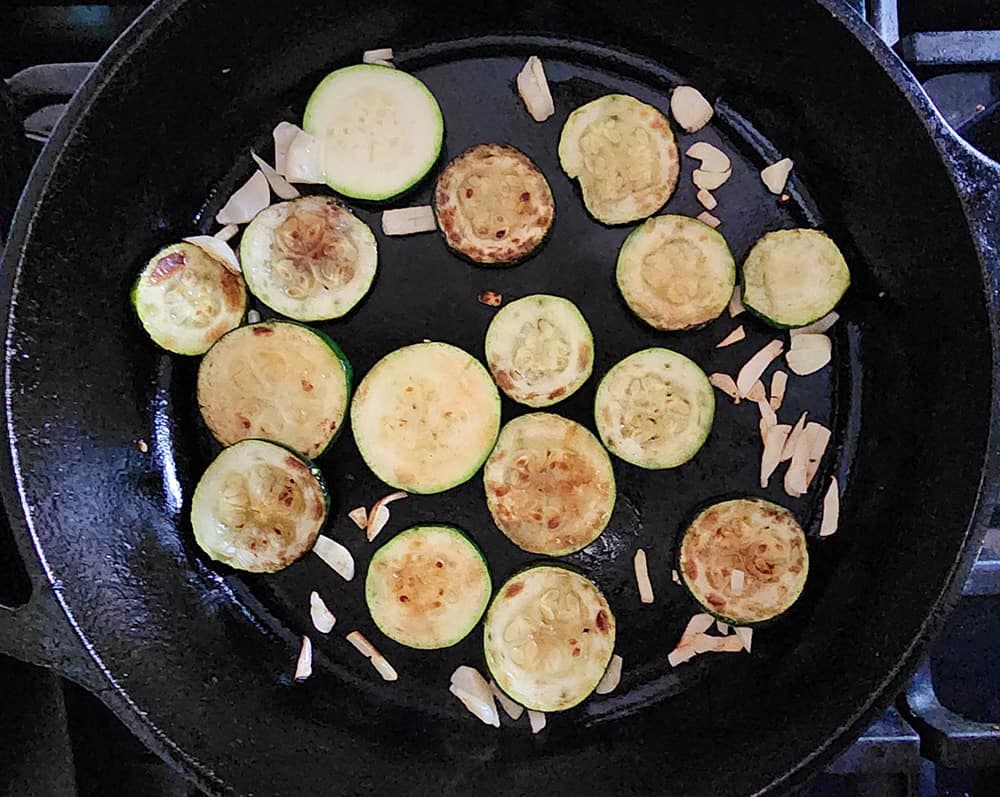 a picture of zucchini slices cooking in a skillet