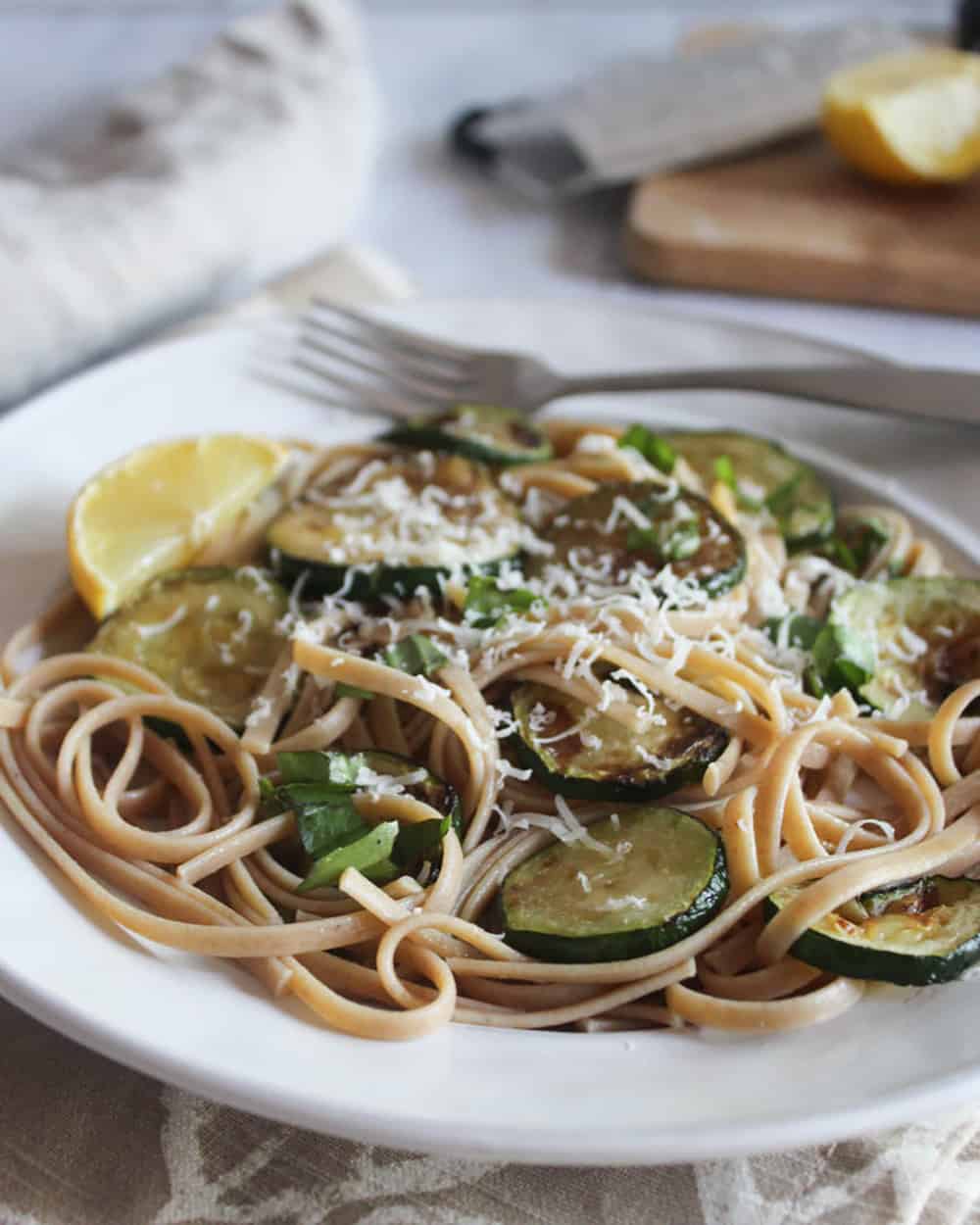 a picture of zucchini pasta on a plate with a fork