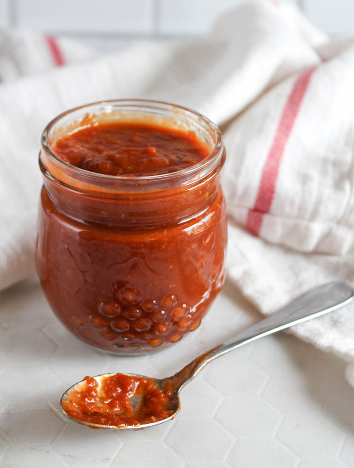 beer bbq sauce in a jar with a spoon