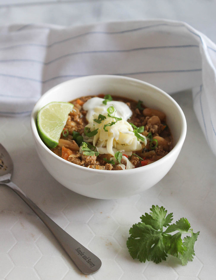 A bowl of turkey chili soup witha spoon