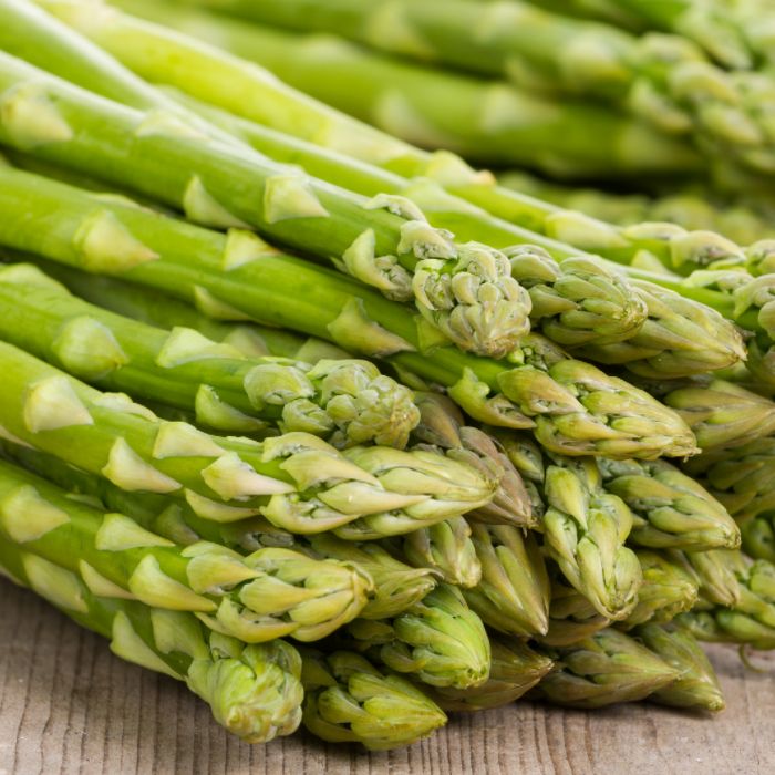 uncooked asparagus on a cutting board