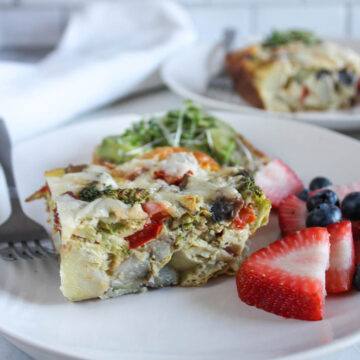 Breakfast Casserole on a plate with strawberries