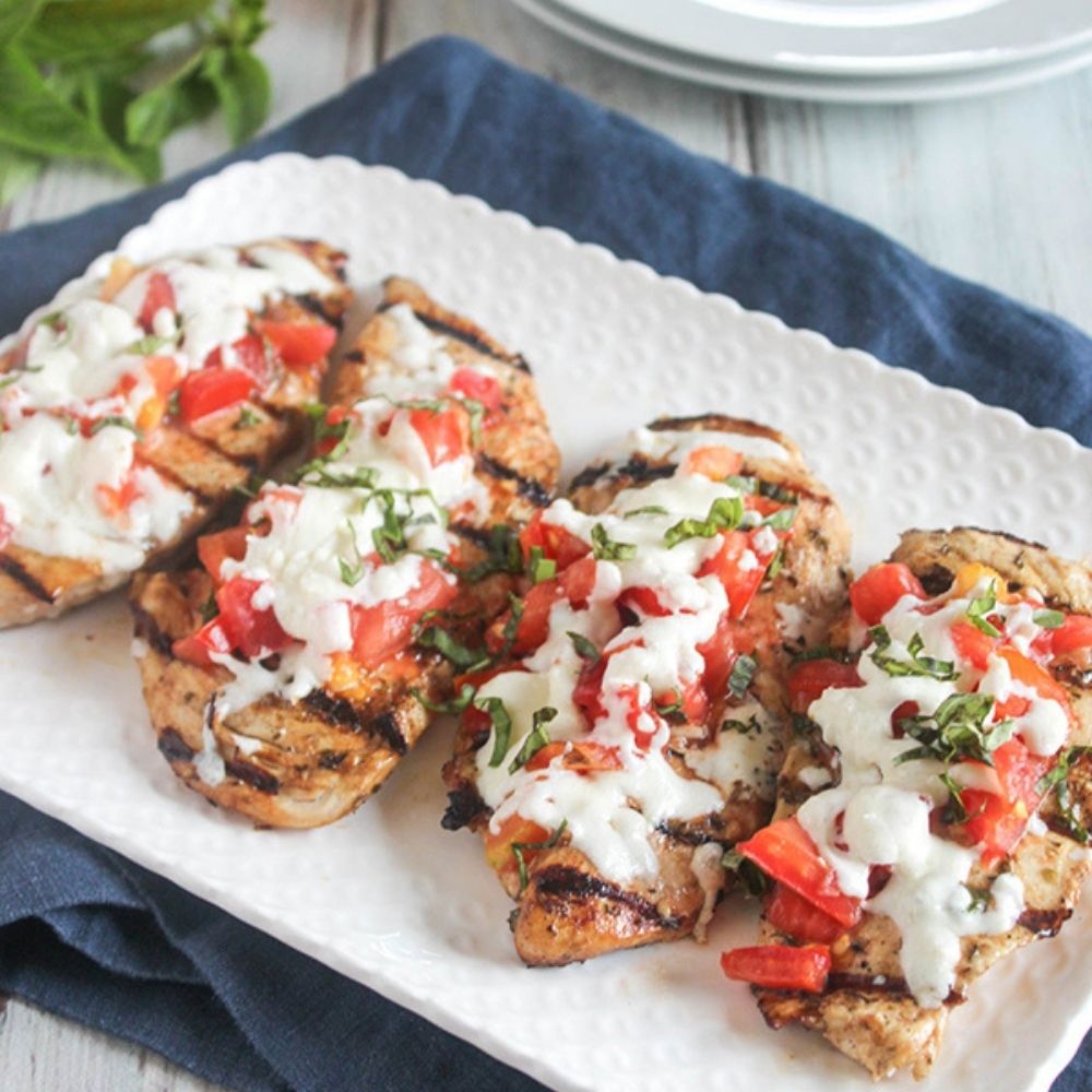 a picture of grilled chicken parmesan on a plate