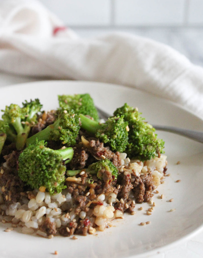 Ground beef and broccoli on a plate with sesame seeds