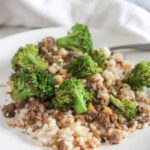 a picture of ground beef with broccoli on a white plate