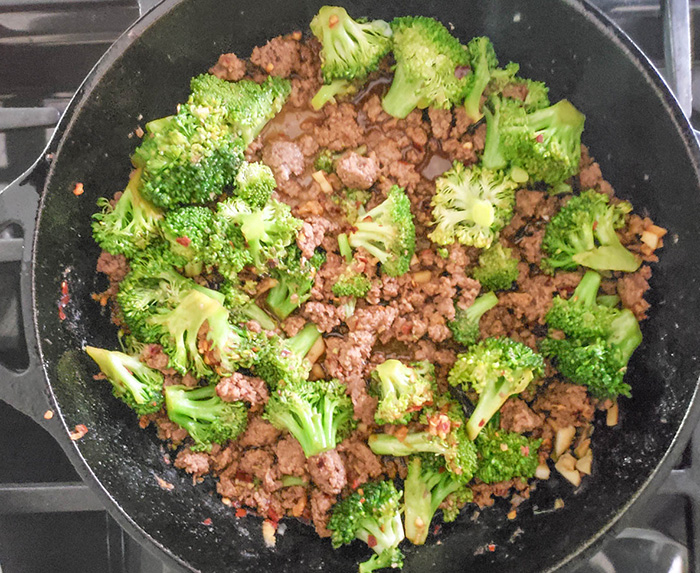 ground beef an broccoli in a skillet