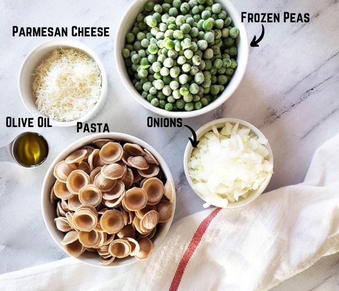 An overhead view of pasta and peas ingredients