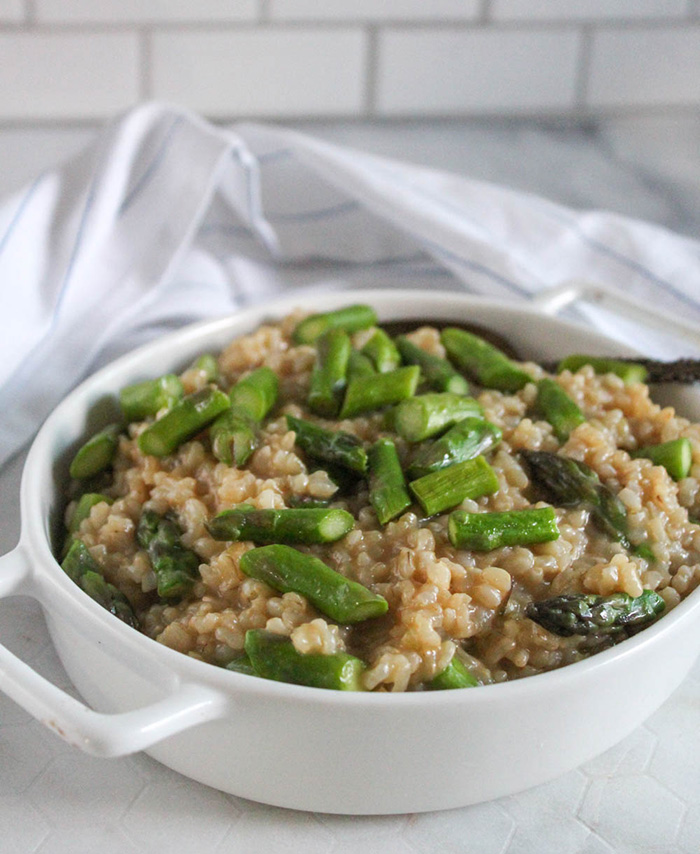 risotto with asparagus in a white bowl