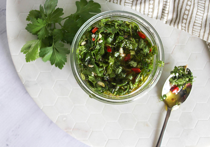chimichurri sauce overhead view with spoon on the side