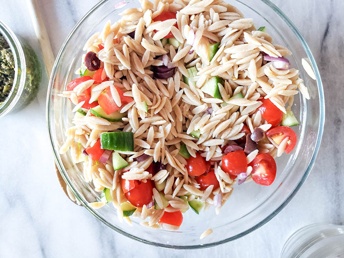 pesto orzo process 2 veggies and pasta in a bowl