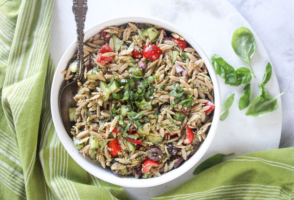 Pesto orzo in a bowl overhead photo