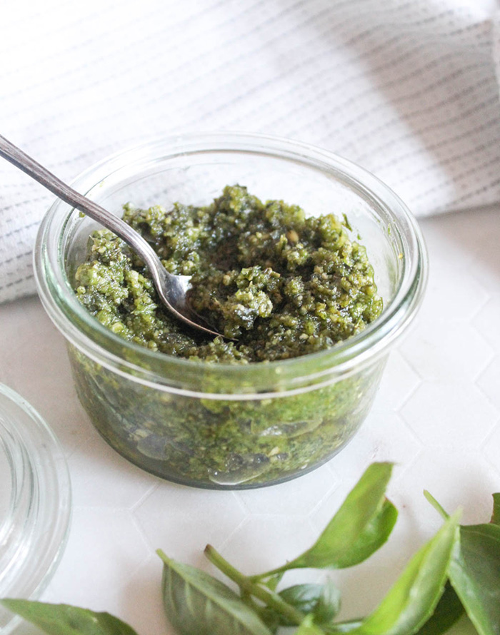 cashew pesto sauce in a jar with a spoon