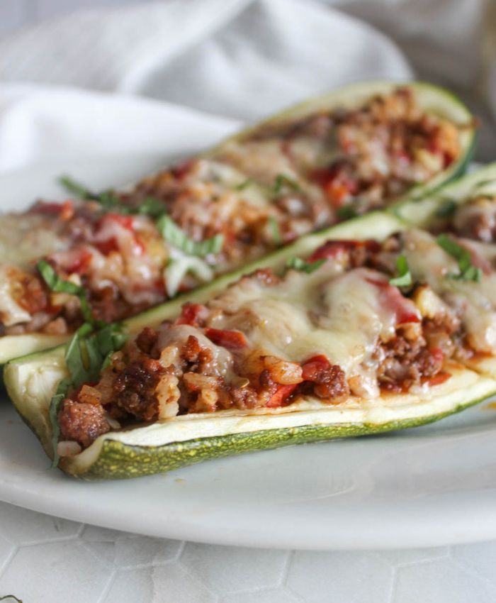 A close up picture of stuffed zucchini on a platter