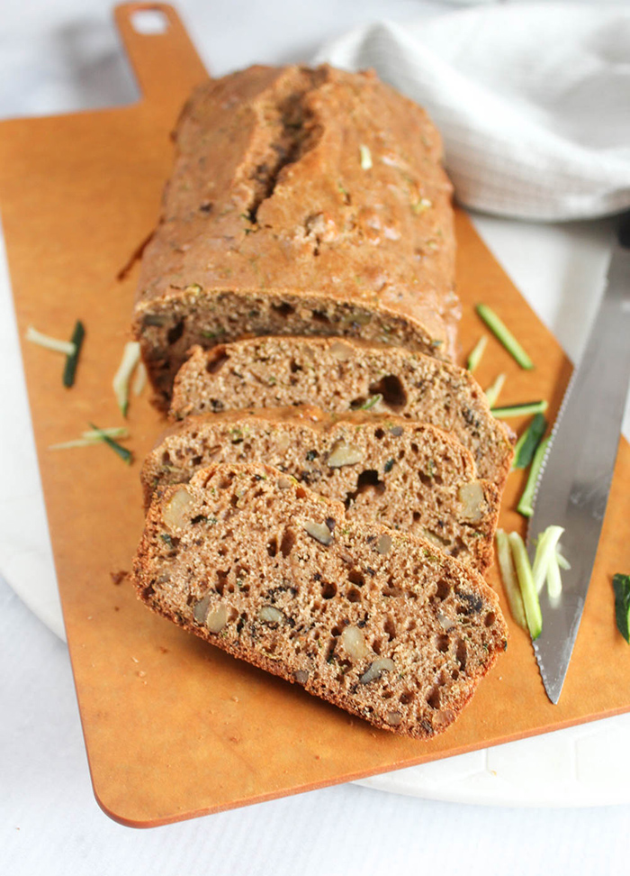 zucchini bread sliced on a cutting board