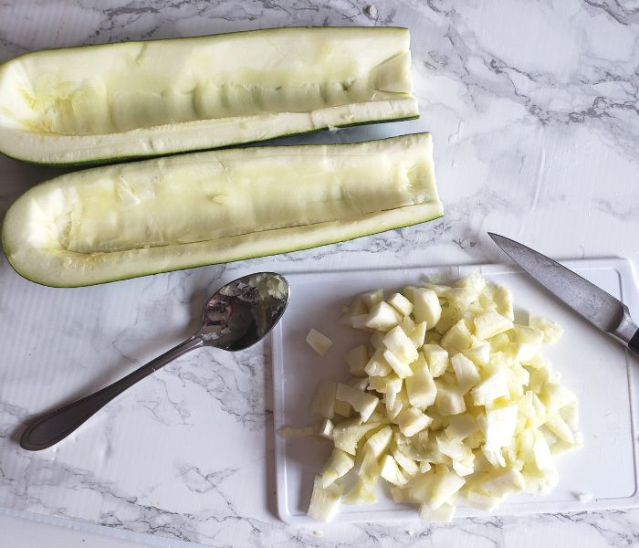 zucchini hollowed out with chopped zucchini pulp on the side