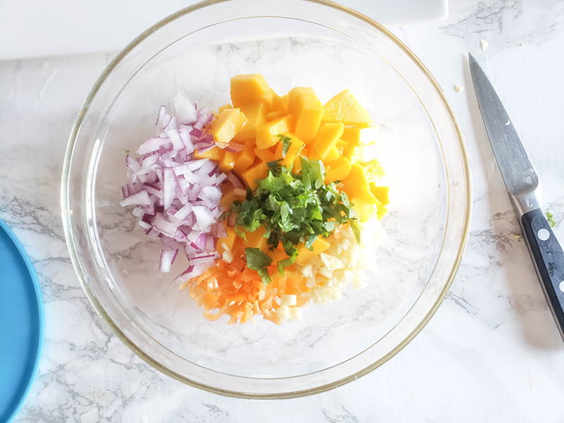 habanero mango salsa ingredients in a mixing bowl