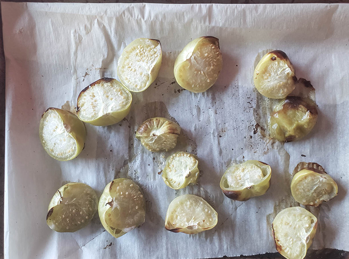 photo of roasted tomatillos on parchment paper