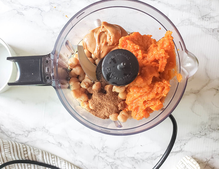 pumpkin hummus ingredients in a food processor