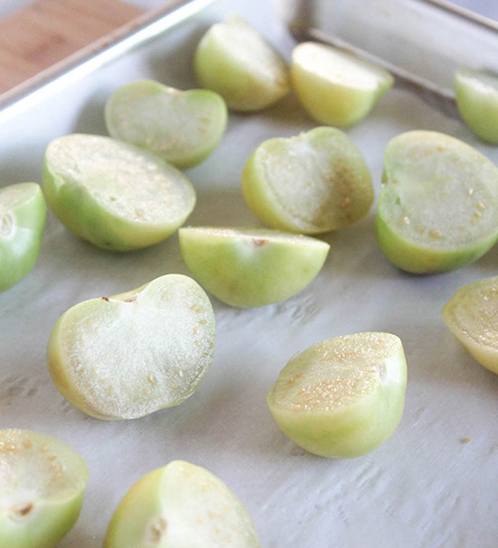 photo of raw tomatillos on a baking sheet