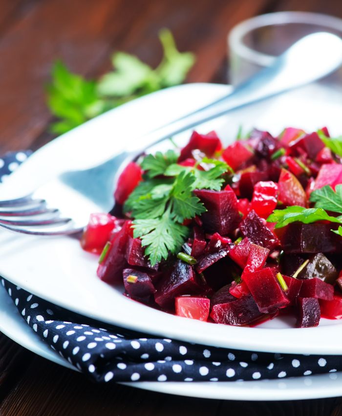 beet salad on a white plate with a fork