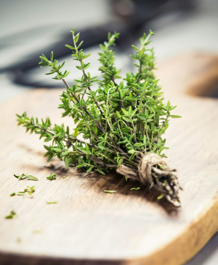 a picture of a bunch of thyme on a cutting board