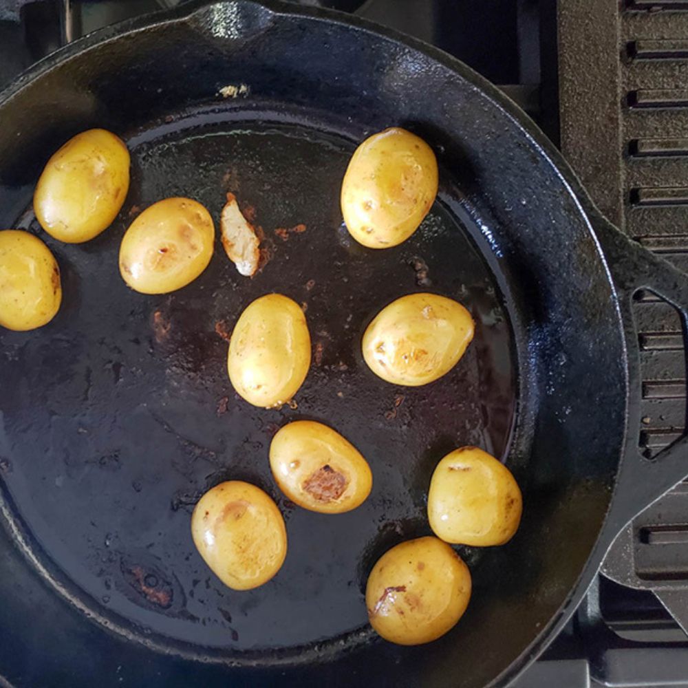 step 2 potatoes cooking in a skillet