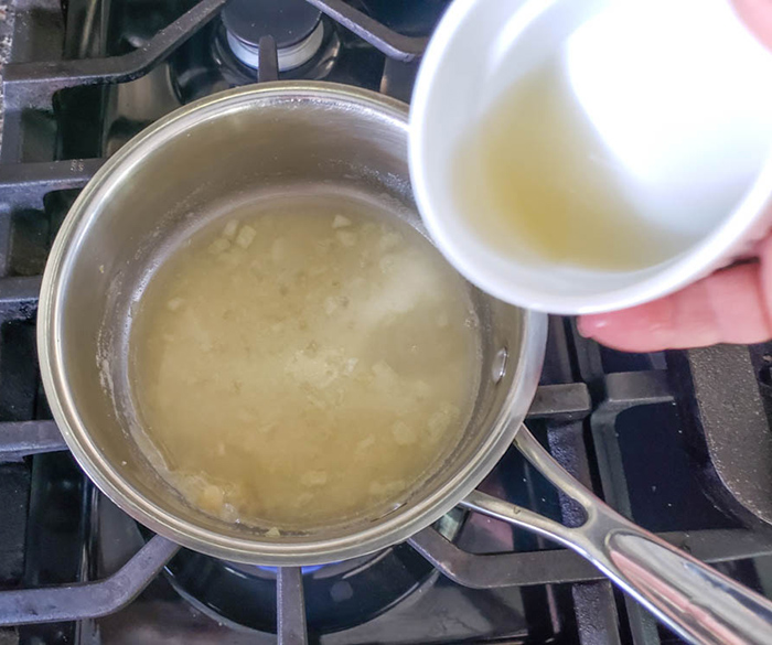 making gravy adding broth