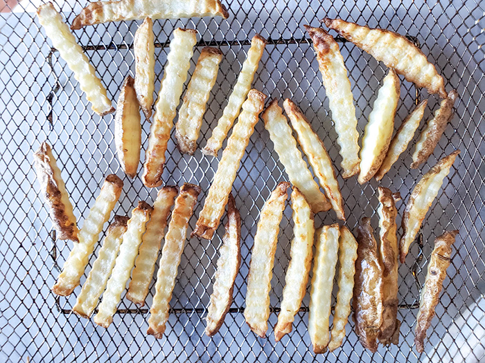 cooked fries on an air fryer basket