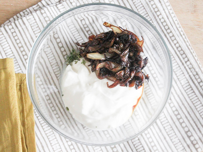 all of ingredients to make  caramelized onion dip in a mixing  bowl