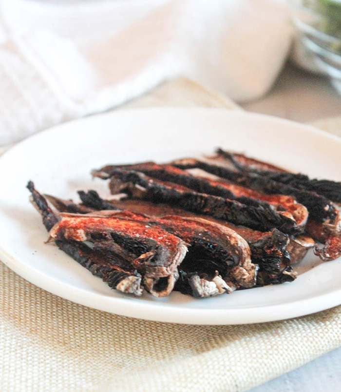 slices of cooked portobello mushrooms on a plate