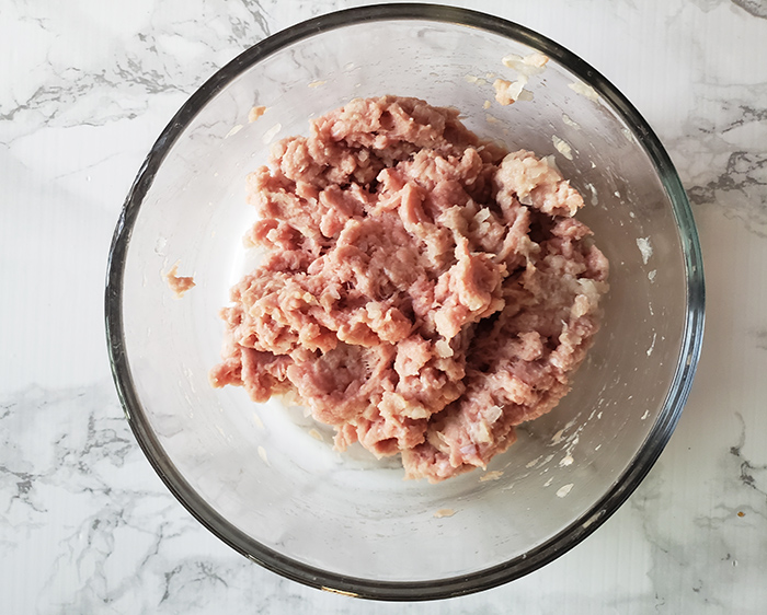 Process shot of ground turkey and onions mixed together