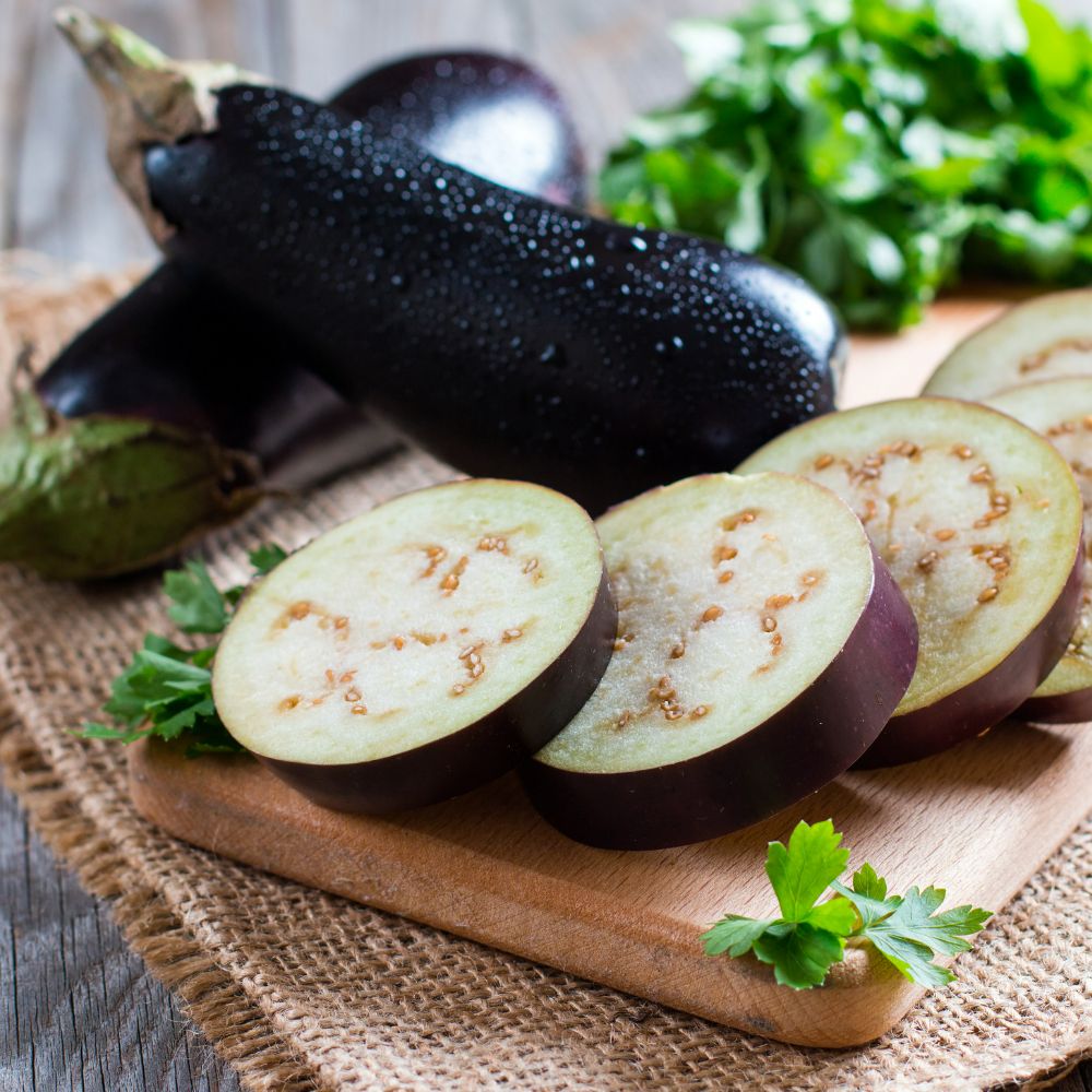 a picture of two eggplants and one sliced