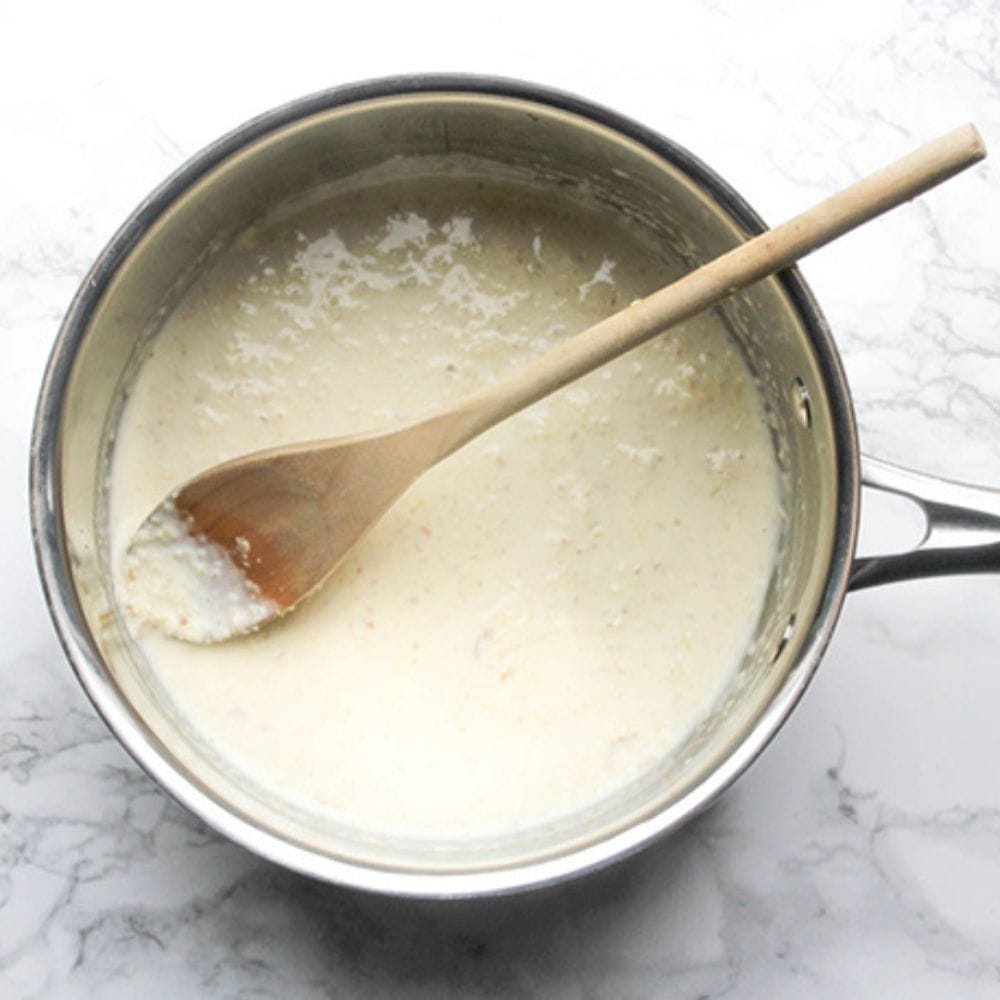 a picture of ginger milk in a pan with a spoon