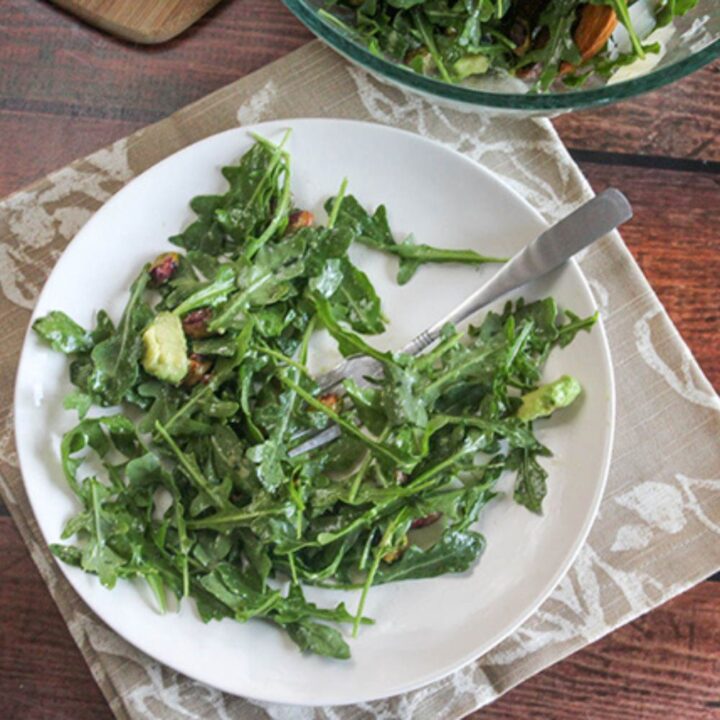 an overhead view of arugula salad on plate