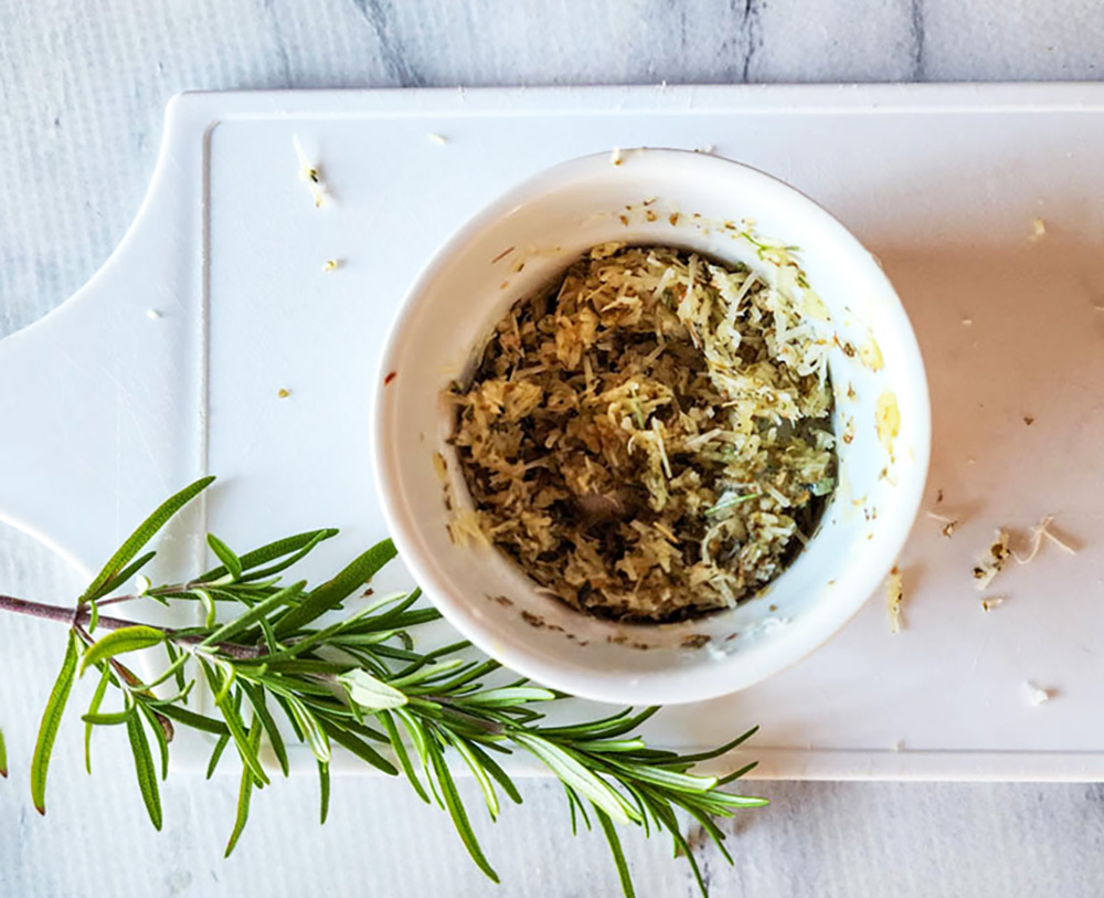 herb mixture with parmsan cheese shreds in a small bowl