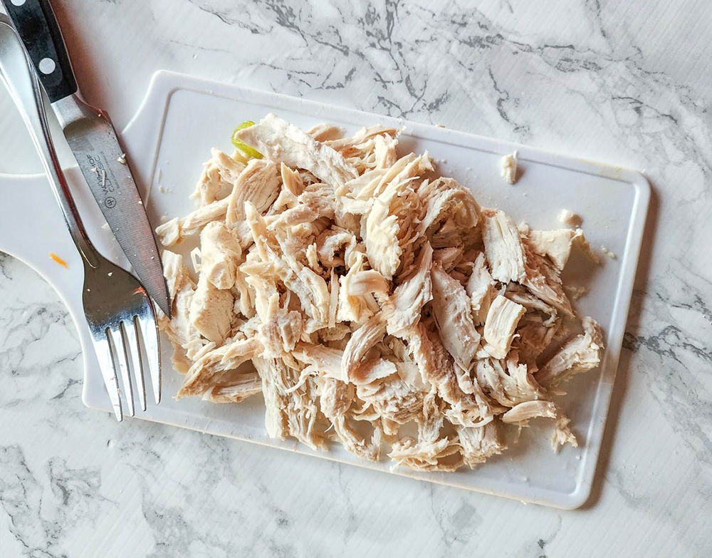 shredded chicken on a board