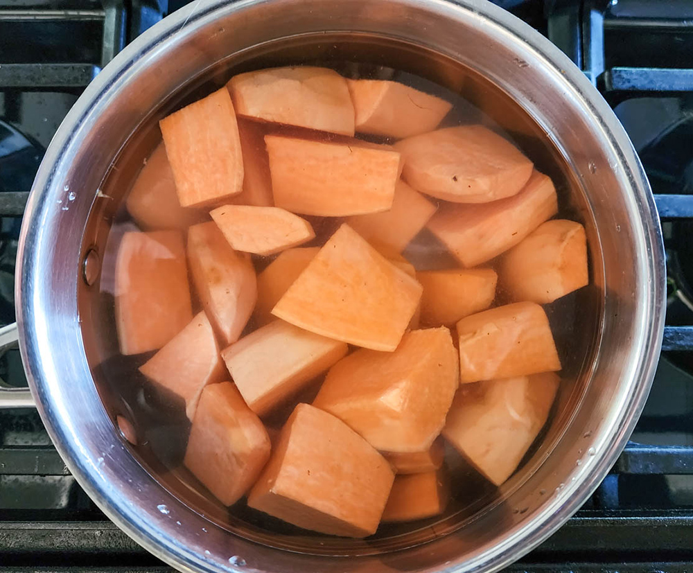 chunks of sweet potatoes in a pot with water