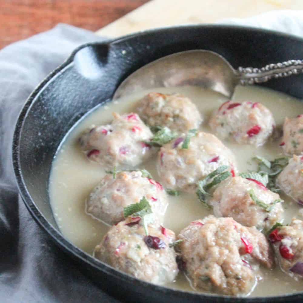 a picture of turkey meatballs in a cast iron skillet